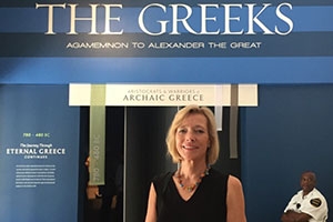 Professor Stogner in front of the The Greeks Exhibit at National Geographic