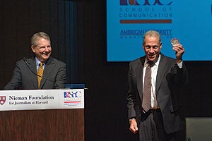 Nieman curator Bob Giles, left, smiles as Jon Alpert displays his I.F. Stone Medal.