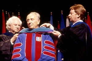 May, 1998: Shimon Peres (center) receives an honorary doctorate from AU. On the left: Howard Wachtel, Center for Israel Studies founding Director. On the right:  Cornelius M. Kerwin, then AU Provost, and current AU President.