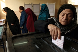 Veiled women casting ballots for a vote.
