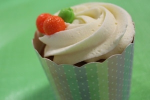 A cupcake with vanilla frosting and berries.