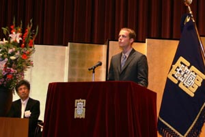 Eric Jensen, a dual degree student, gives a welcome speech in Japanese at the opening of classes at Ritsumeikan University.
