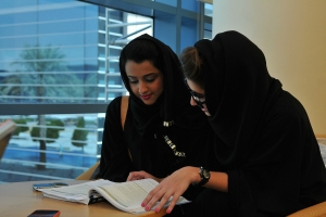 Photo of two women over a book