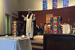 A Catholic chaplain speaks at an interfaith service.