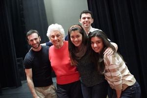 Theatre students embracing Sylvia Greenberg.