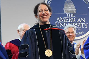 Sylvia Burwell is applauded as she is officially installed at AU's 15th president. She stands in her regalia, wearing the presidential medal.