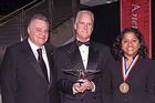 Gary Abramson, SPA/BA ’68, chairman of the Board of Trustees, stands at left with President’s Award recipient Jack Cassell and Cyrus Ansary Medal recipient Esther Benjamin
