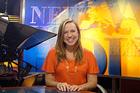 Casey Pallenik, '08, sits behind the news desk on the set of The NewsHour with Jim Lehrer