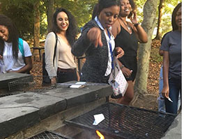  Healing Circle participants throwing their worries into the fire pit