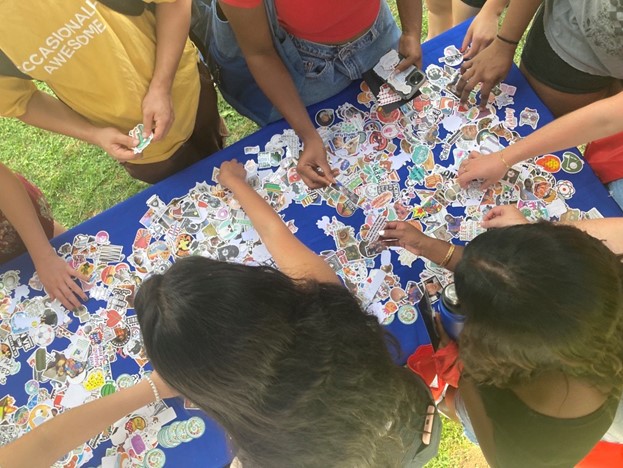 students grabbing water bottle stickers