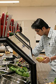 Student looking at salad bar selection in cafeteria