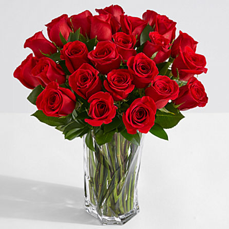 Two dozen red roses in a glass vase