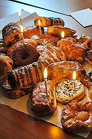 Assortment of Belgian pastries with candles in them for a birthday celebration.