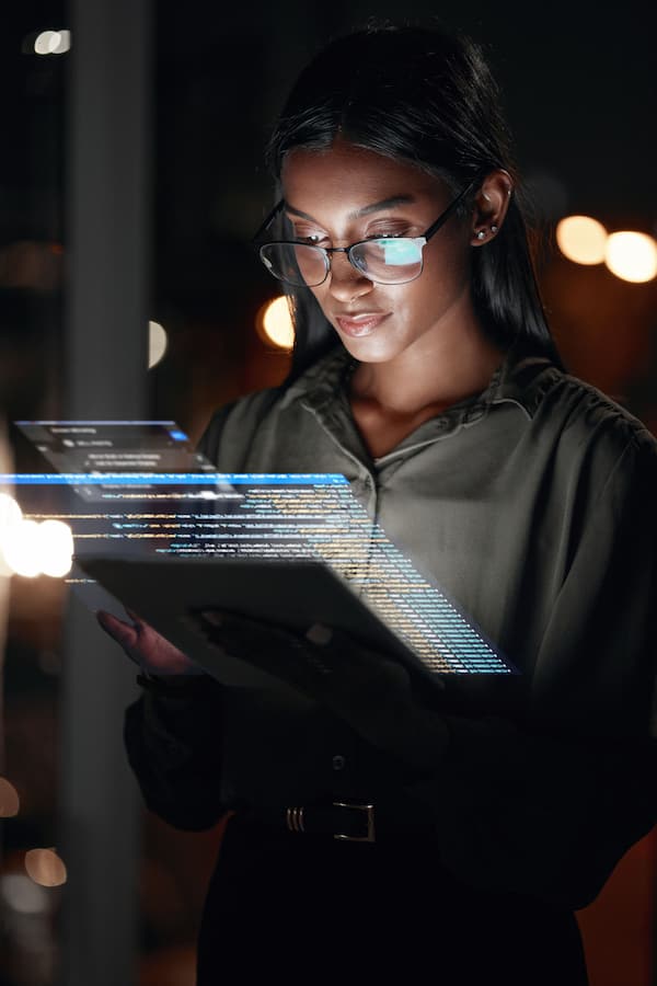 Person in black business casual attire with display devices.