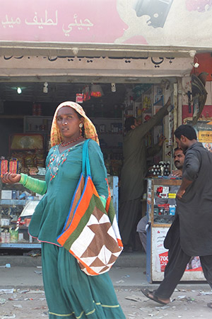 Woman in headress in Arabic-language marketplace