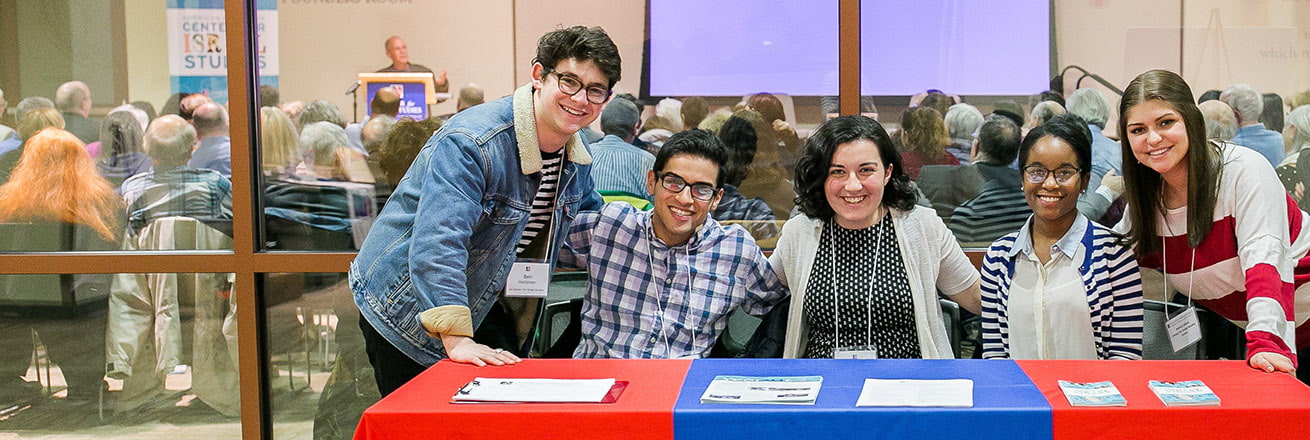 Five students at a table at the Meir Shalev event