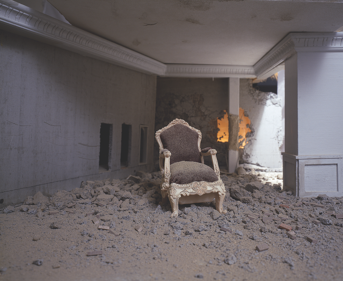 Photograph of a chair inside of a burnt interior