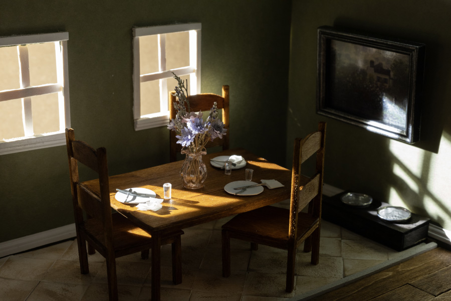 Best and Worst by Connor Gagne. Miniature dining room with three places set and flowers on the table. 