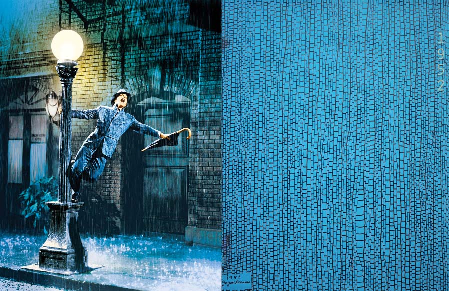 Screen capture from Singin In The Rain of man swinging from lamppost opposite blue and black abstract painting that evokes the wet bricks from the film still, or cells under a microscope. 