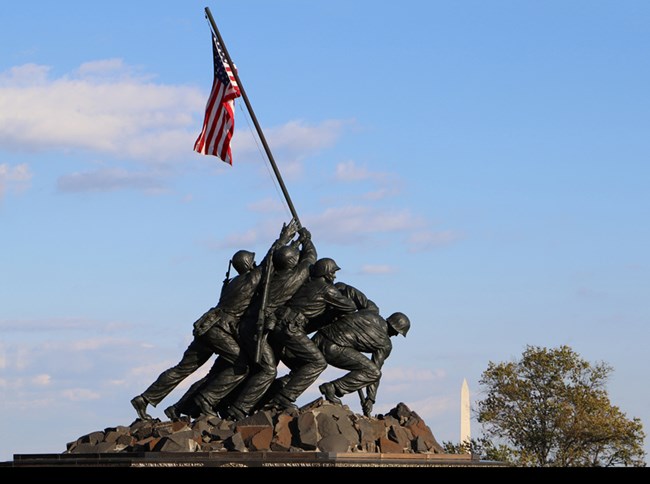 statue of men struggling to raise American flag