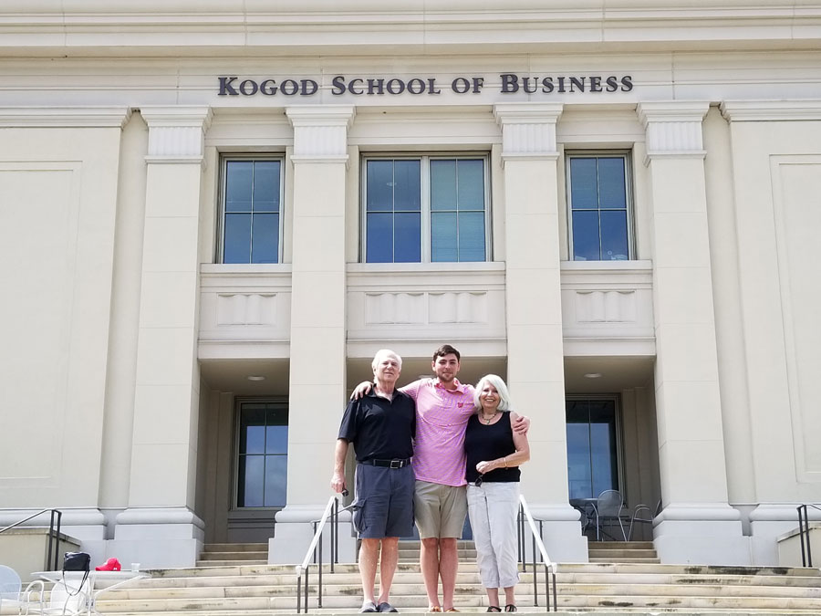 Ellen and Mark Levine with grandson Justin in front of AU's Kogod School of Business