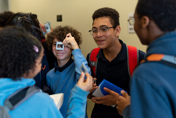 Visiting students use polarization filters at the Optics Olympiad