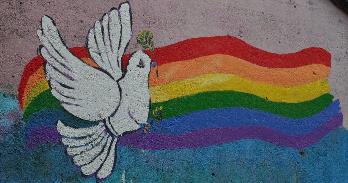 Mural of white dove in front of rainbow. Credit: Paul Moody