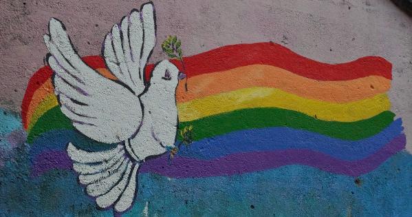 Mural of white dove in front of rainbow. Credit: Paul Moody