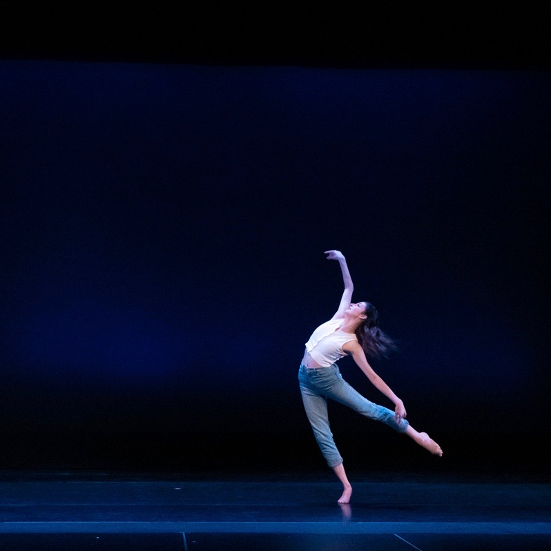 Dancer balances on one foot, limbs outstretched