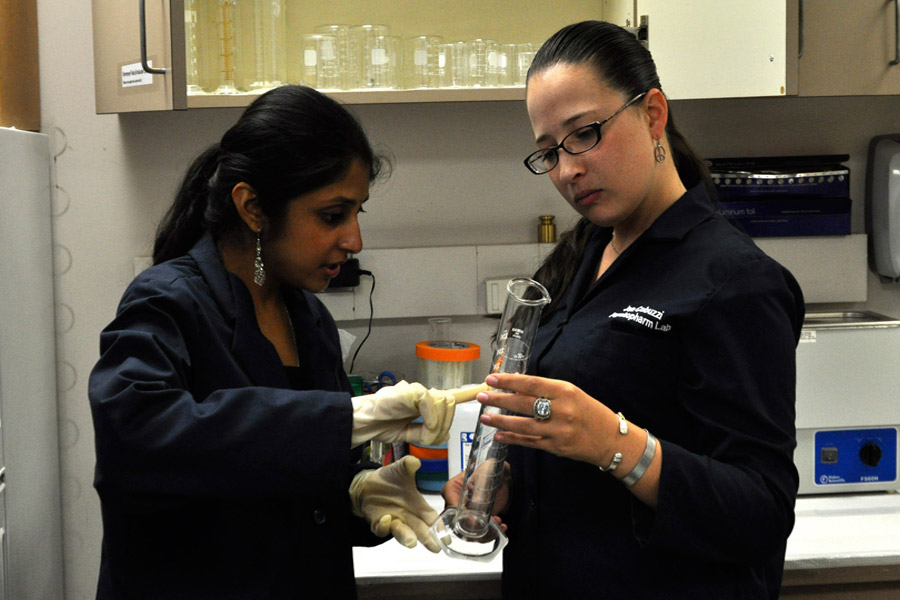 Students examine a piece of lab equipment