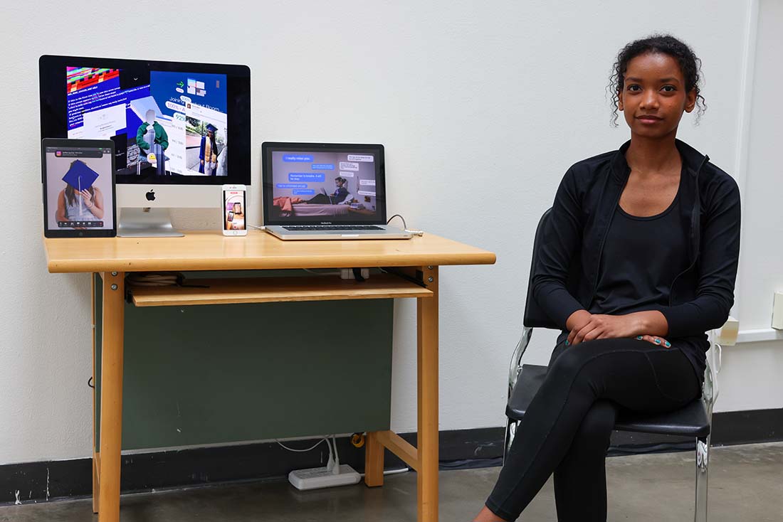 Anya Martinez with artwork: digital art installation with motion graphics on computer, smartphone, and tablet screens