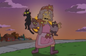 Simpsons woman carries six cats.