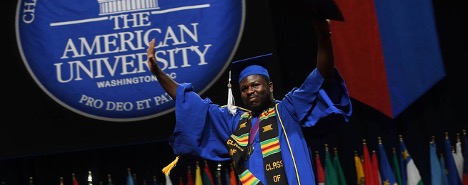 African American Student on stage in front of an AU sign