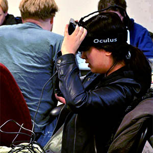 A young woman wearing an Oculus virtual reality headset