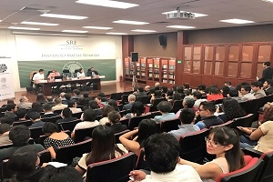 Audience in an auditorium listening to a panel