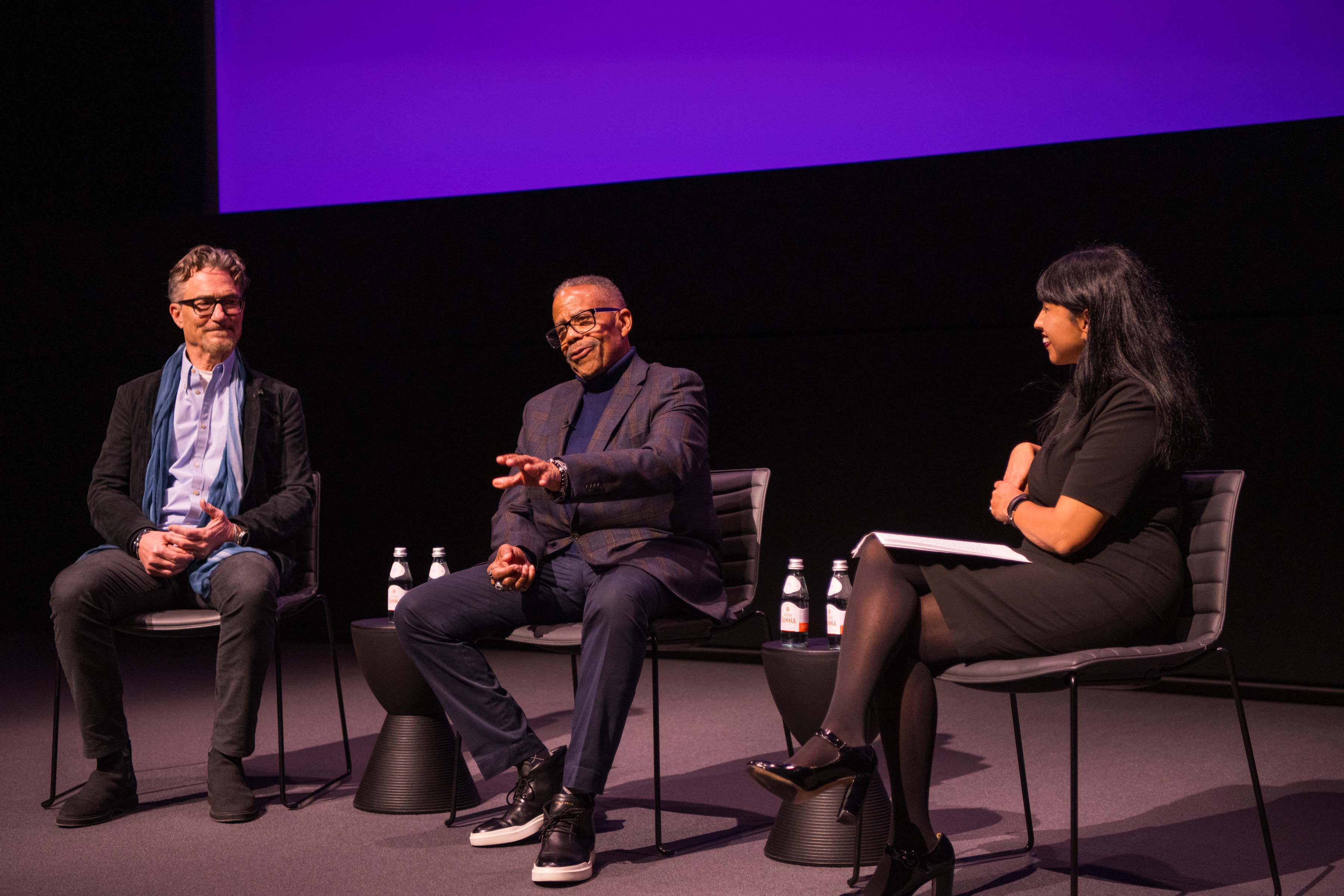 Russell Williams II, SOC/BA ’74, and Barry Josephson, SPA/BA ’78, on stage with  SOC Interim Dean Leena Jayaswal at the Academy Museum of Motion Pictures.