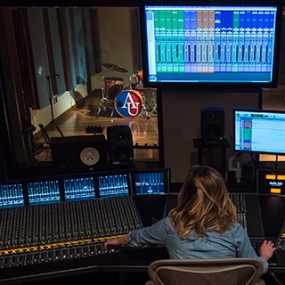 An audio technology student mixes music using American University's state-of-the art equipment. 