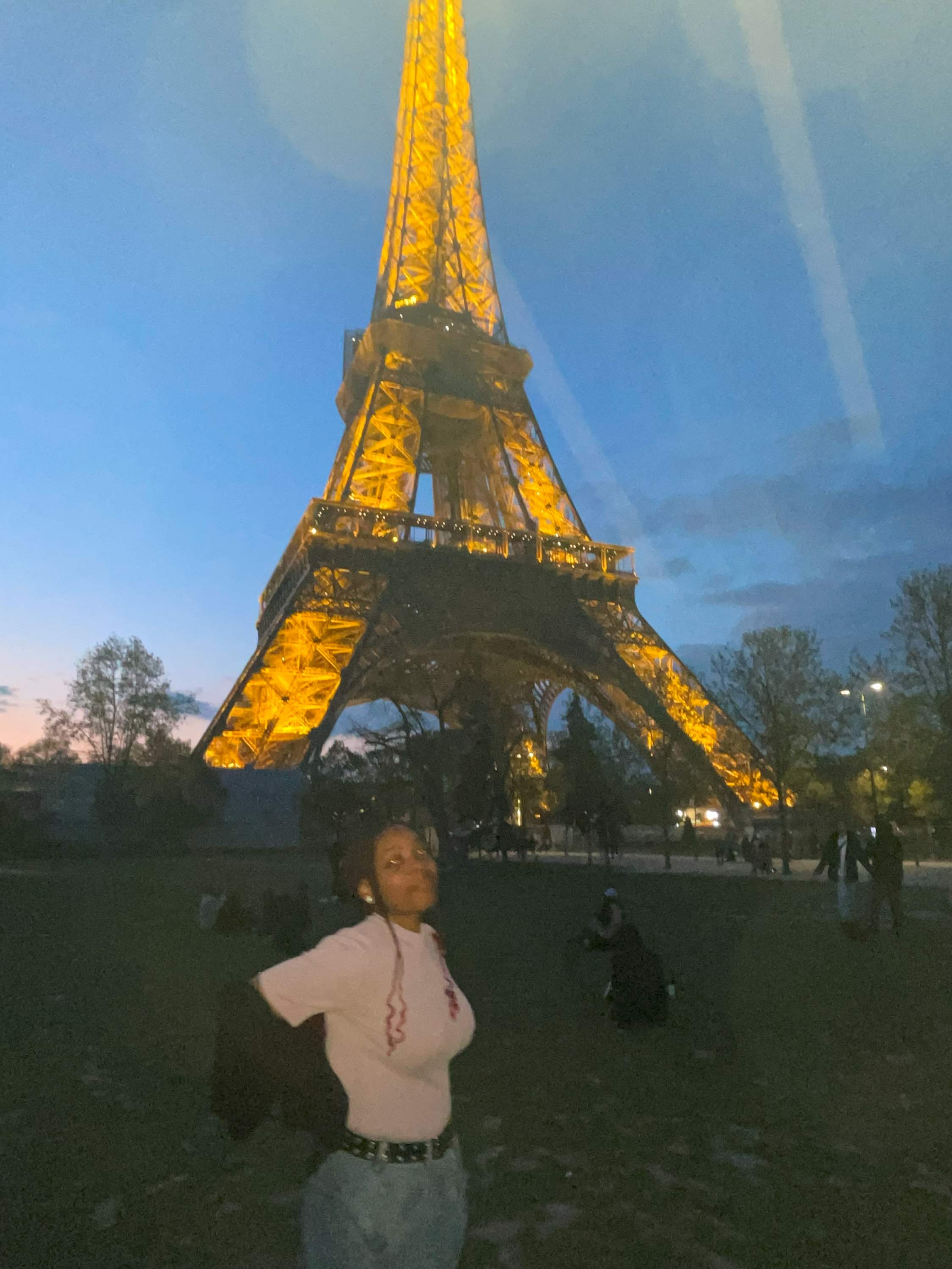 Ayawni standing in front of eiffel tower