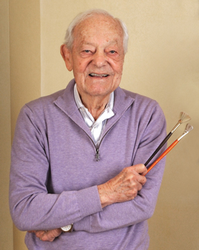 Bob Schieffer holding his paintbrushes