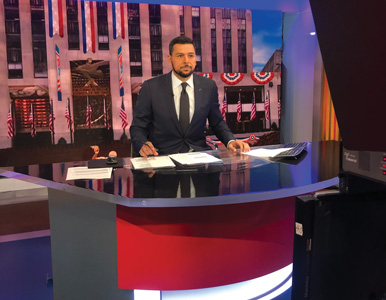 Ayman Mohyeldin behind the anchor desk at MSNBC