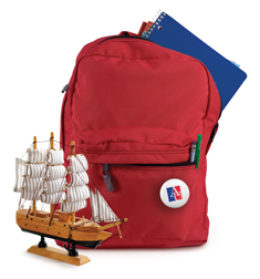 red backpack with tiny wooden ship