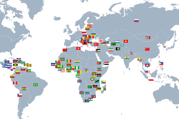 map of the world with flags marking the 107 countries where AU grads have served