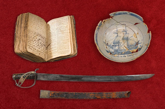 an old book, a broken plate, and a sword