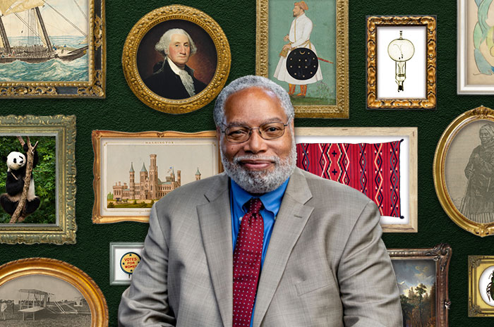 Lonnie Bunch standing in front of a gallery wall