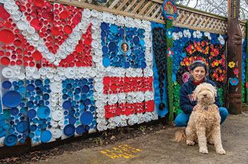 karen Lash and her dog Lucky in front of her backyard mosaics