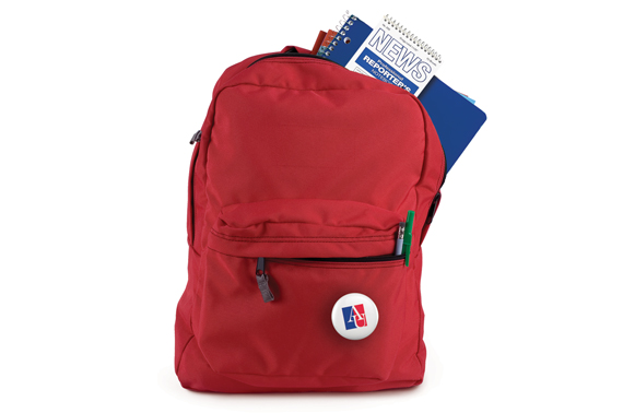 red backpack with a reporter's notebook sticking out