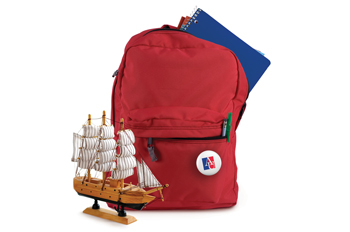 red backpack with tiny wooden ship