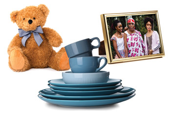 teddy bear stack of blue plates and mugs and photo of three women in gold frame