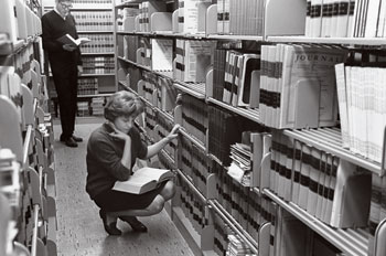 From the archives: a female student in the Washington College of Law library
