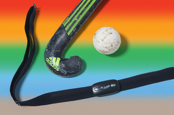 A field hockey stick, ball, and heart monitor